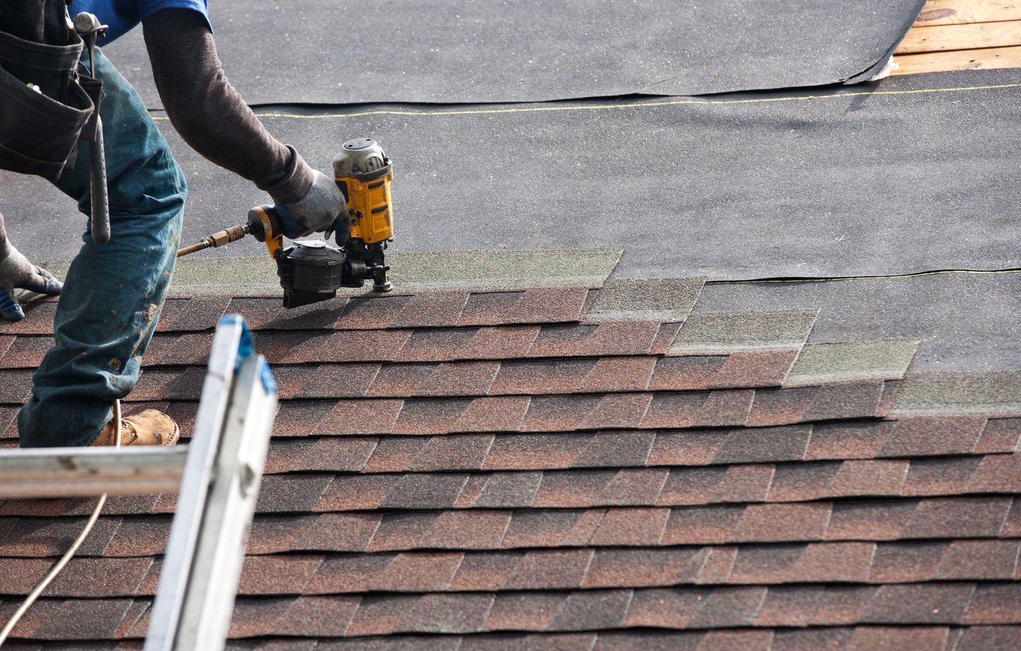 roofers installing new roof on house